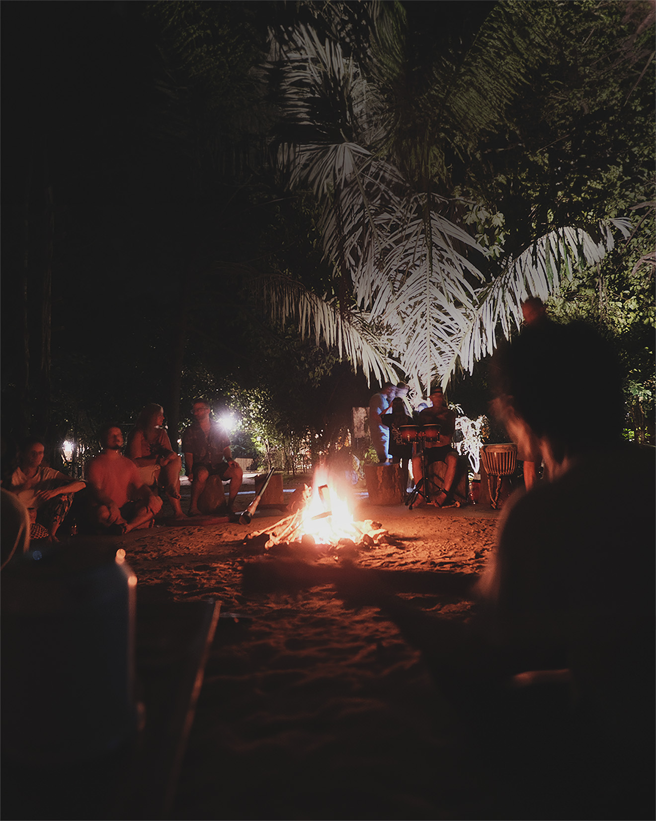 An evening jam session around a fire in the cave