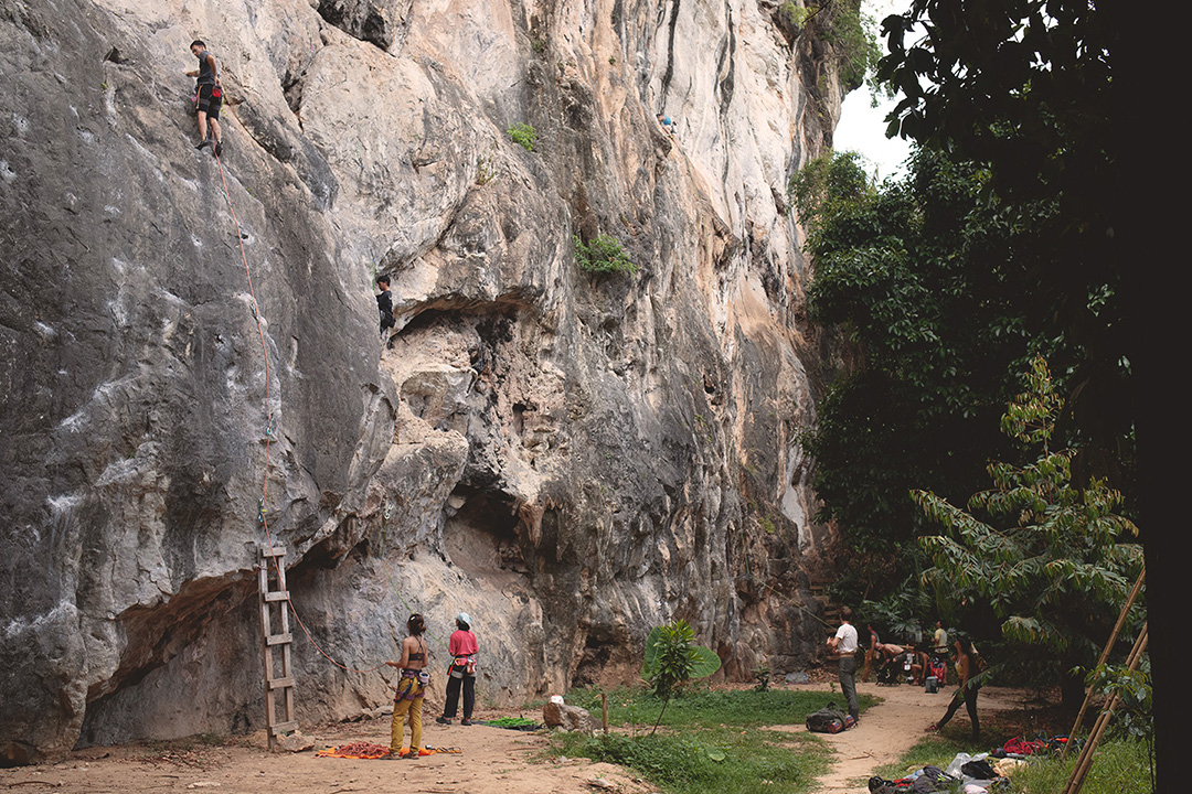 Climbers at the base of the limestone wall